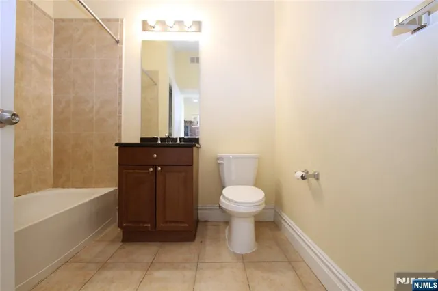 a bathroom with a sink a toilet and bathtub