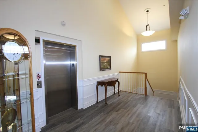 a very nice looking room with wooden floor and bathroom