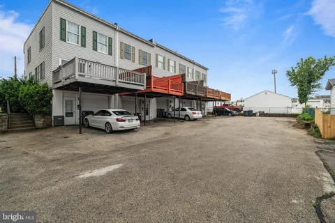 a car parked in front of a white building