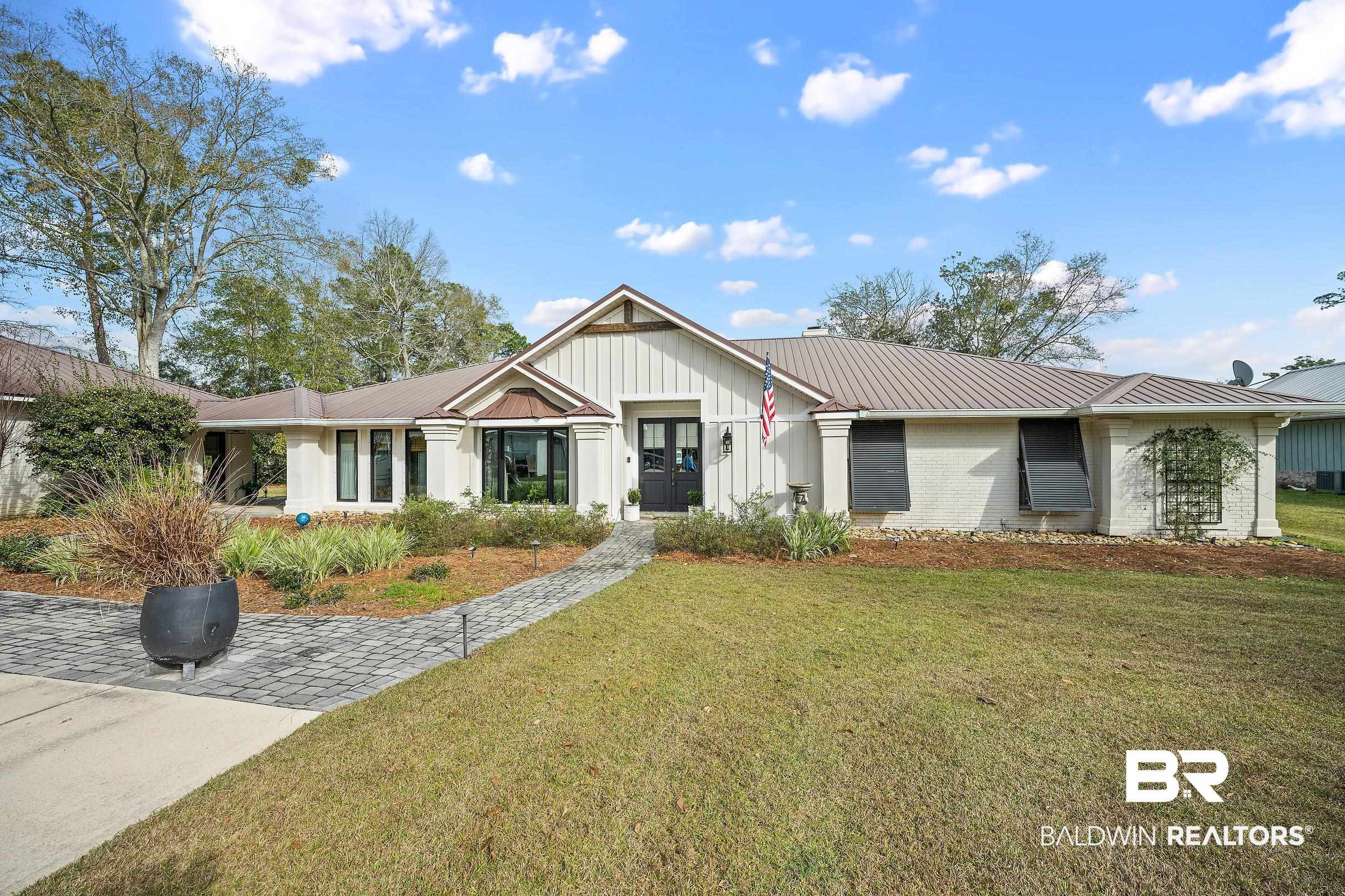 8490 Bay View Drive Foley, AL 36535 - Photo 17 of 67 View of front of property with a metal roof, a front yard, brick siding, and board and batten siding