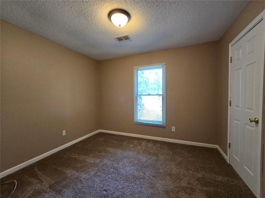 375 Old Brock Road Rockmart, GA 30153 - Photo 12 of 16 an empty room with a empty space and a window
