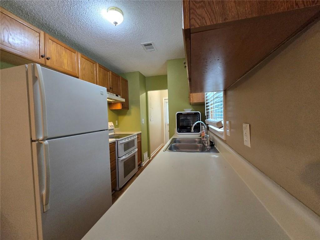 375 Old Brock Road Rockmart, GA 30153 - Photo 3 of 16 a kitchen with stainless steel appliances a refrigerator and a sink