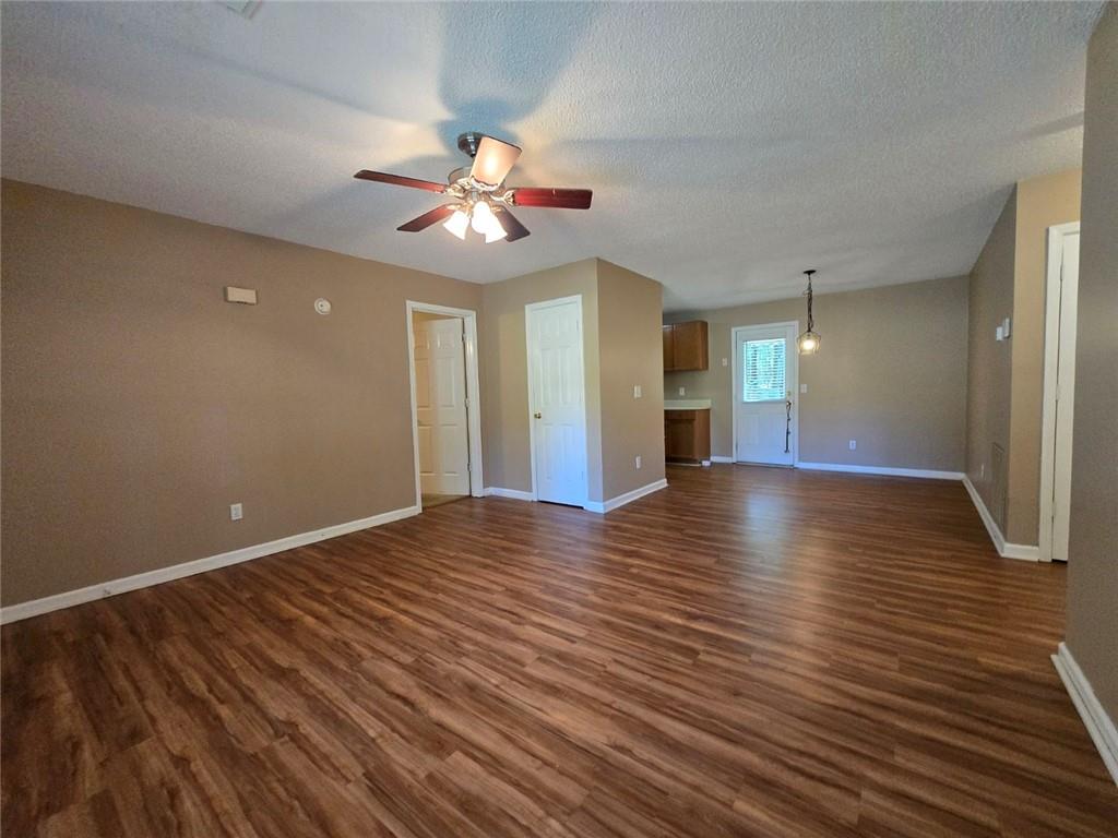 375 Old Brock Road Rockmart, GA 30153 - Photo 4 of 16 a view of an empty room with wooden floor and a ceiling fan