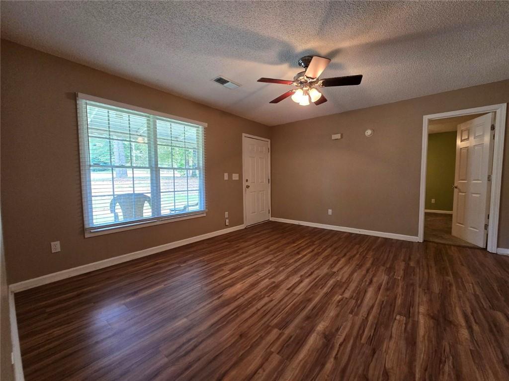 375 Old Brock Road Rockmart, GA 30153 - Photo 6 of 16 a view of an empty room with wooden floor and a window
