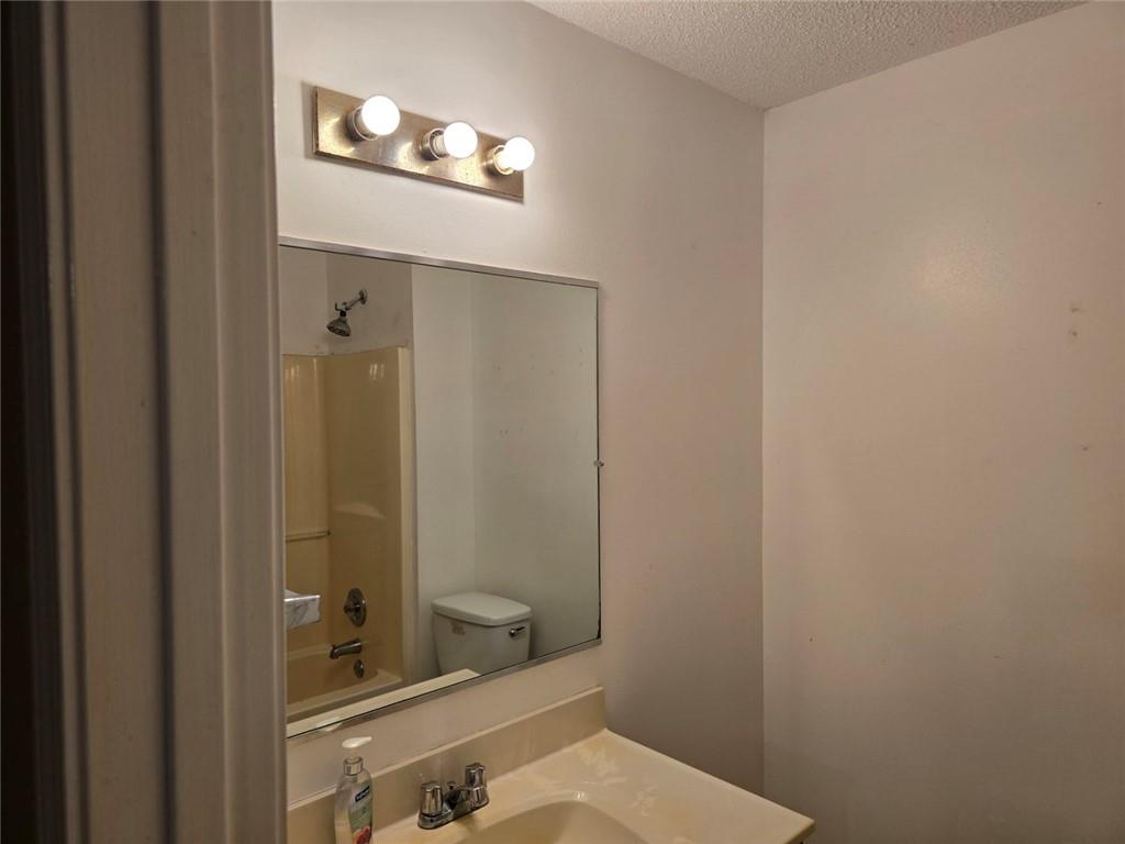 375 Old Brock Road Rockmart, GA 30153 - Photo 9 of 16 a bathroom with a sink and mirror with toilet