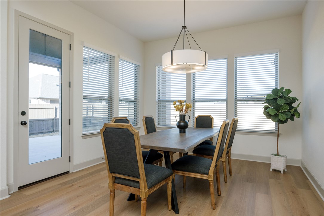 4007 Pacific Crest Way Bryan, TX 77802 - Photo 13 of 28 a view of a dining room with furniture window and wooden floor