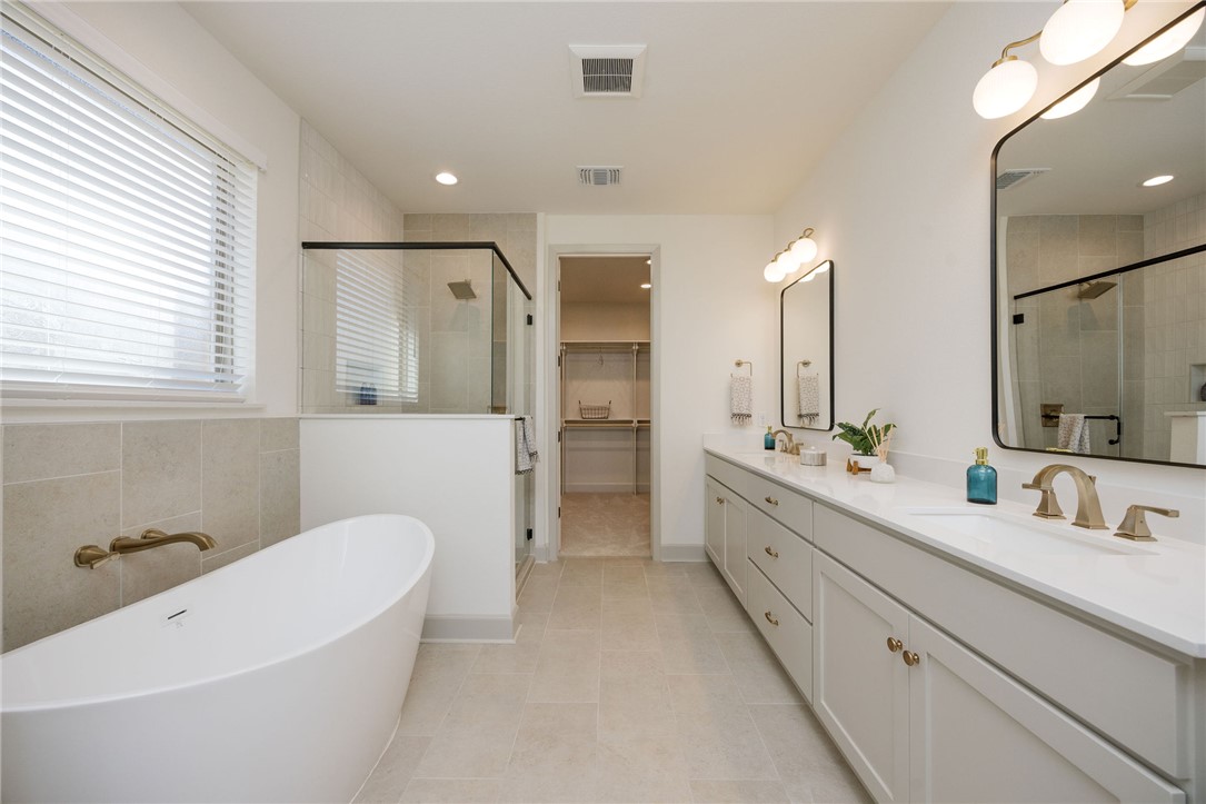 4007 Pacific Crest Way Bryan, TX 77802 - Photo 21 of 28 a bathroom with a double vanity sink mirror and bathtub