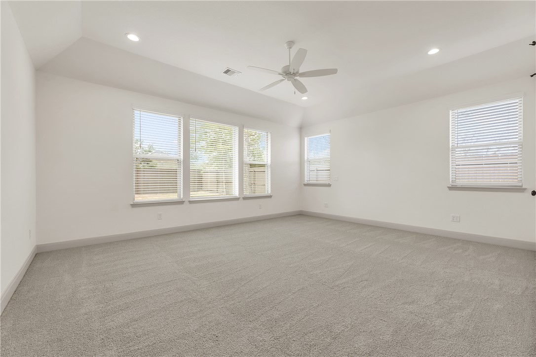 4007 Pacific Crest Way Bryan, TX 77802 - Photo 22 of 43 an empty room with windows and ceiling fan