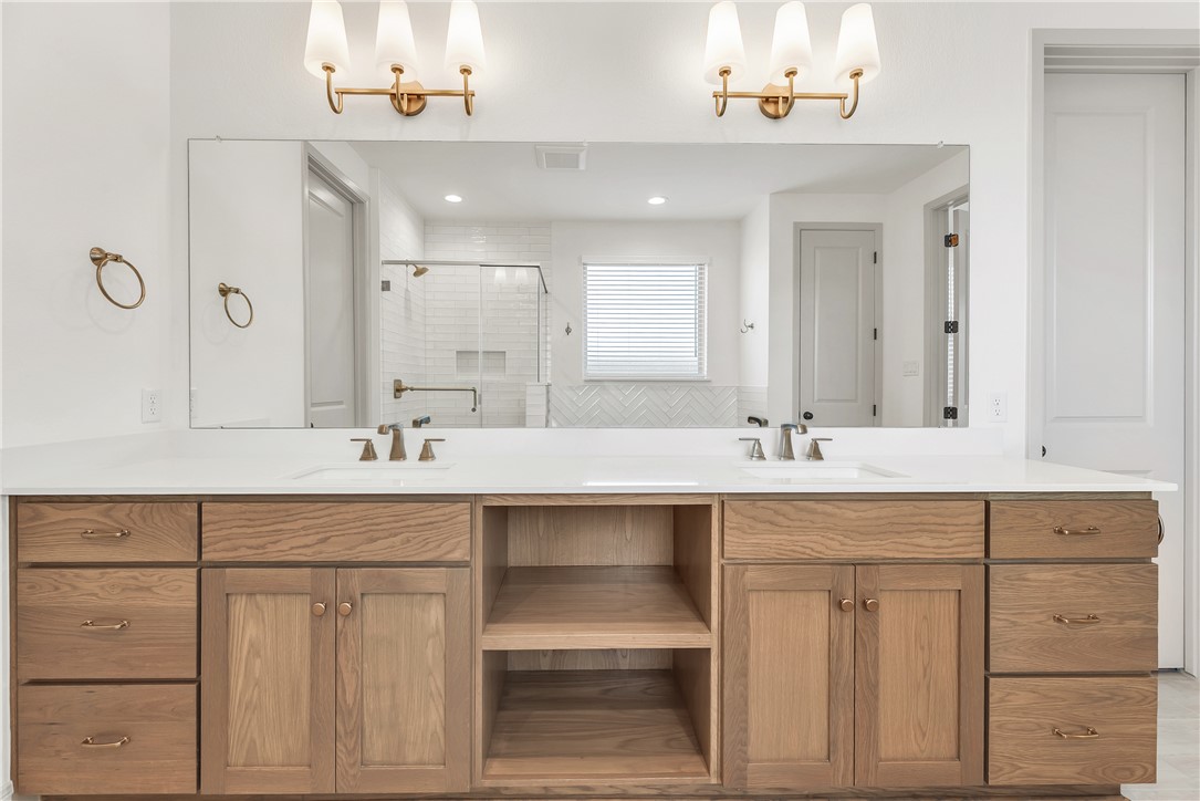 4007 Pacific Crest Way Bryan, TX 77802 - Photo 26 of 43 a bathroom with a sink vanity and mirror
