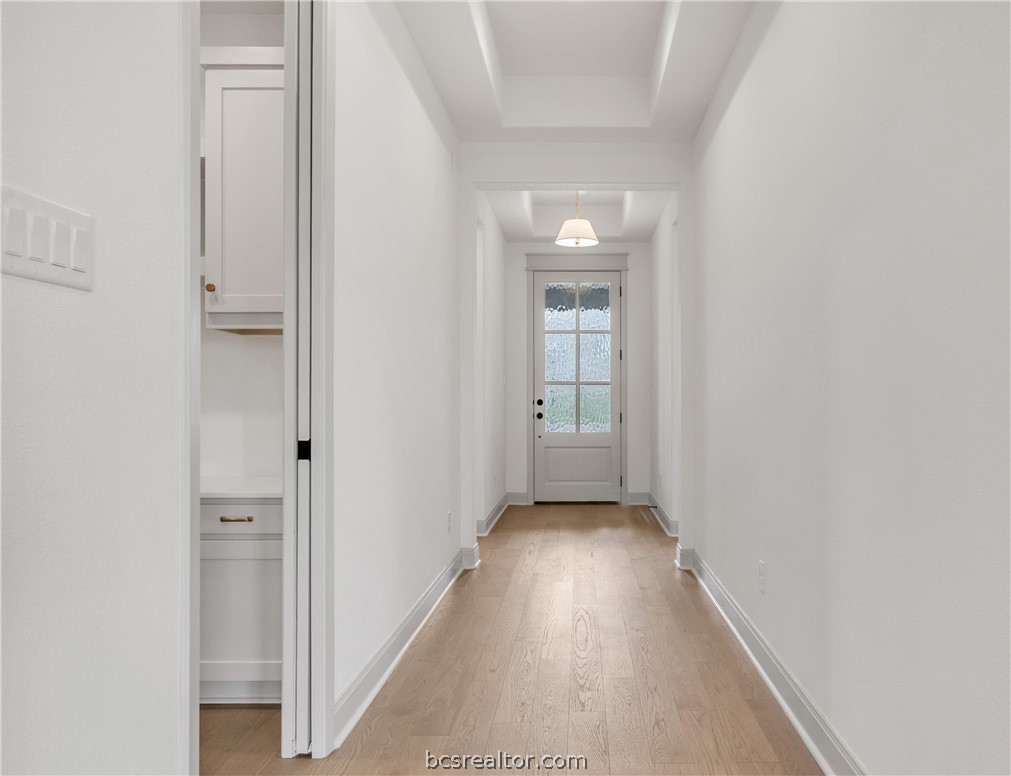 4007 Pacific Crest Way Bryan, TX 77802 - Photo 3 of 43 a view of a hallway with wooden floor and a bathroom