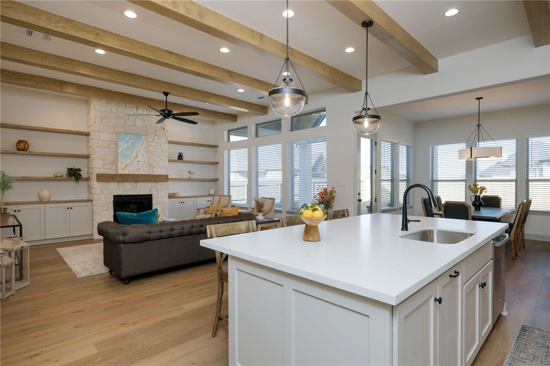 4007 Pacific Crest Way Bryan, TX 77802 - Photo 6 of 28 a kitchen with a stove a refrigerator and a fireplace