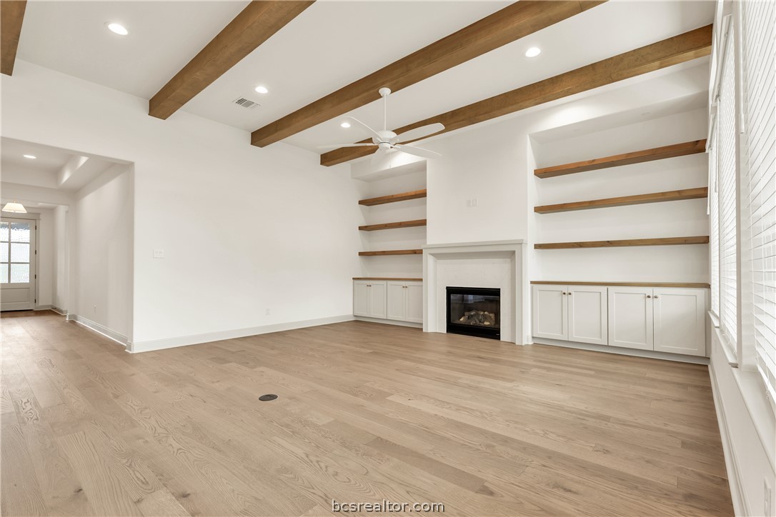 4007 Pacific Crest Way Bryan, TX 77802 - Photo 7 of 43 a view of an empty room with a fireplace and a window