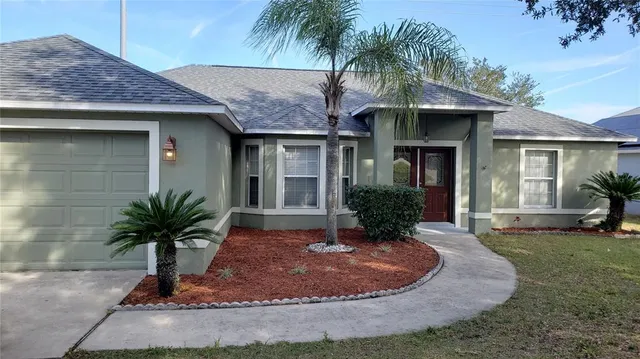 a view of a house with a yard potted plants