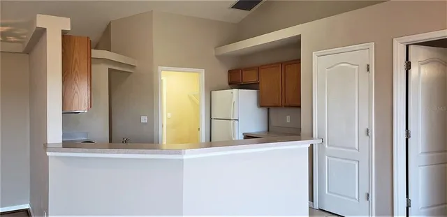 a room that has a refrigerator and a dresser