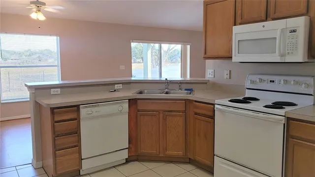 a kitchen with a stove microwave and sink