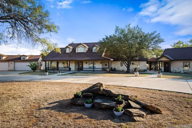 a view of a house with pool and sitting area