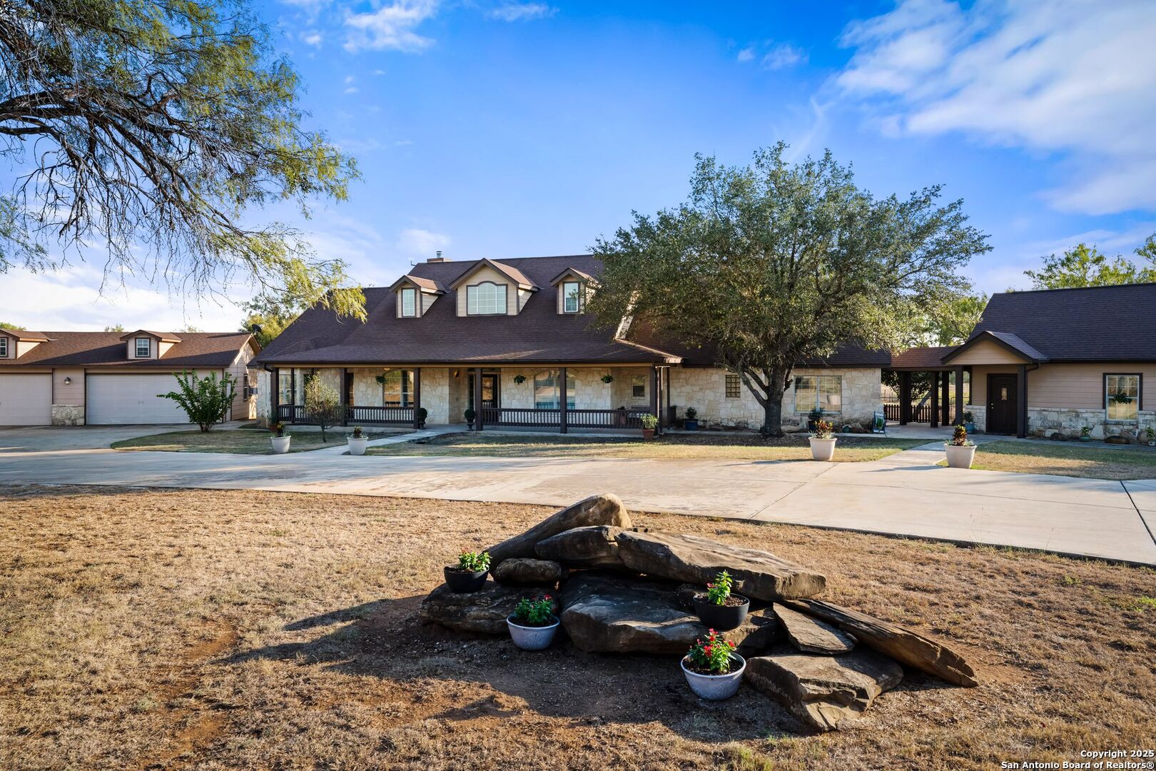 765 Highway 1604 Loop St. Hedwig, TX 78101 - Photo 1 of 50 a view of a house with pool and sitting area