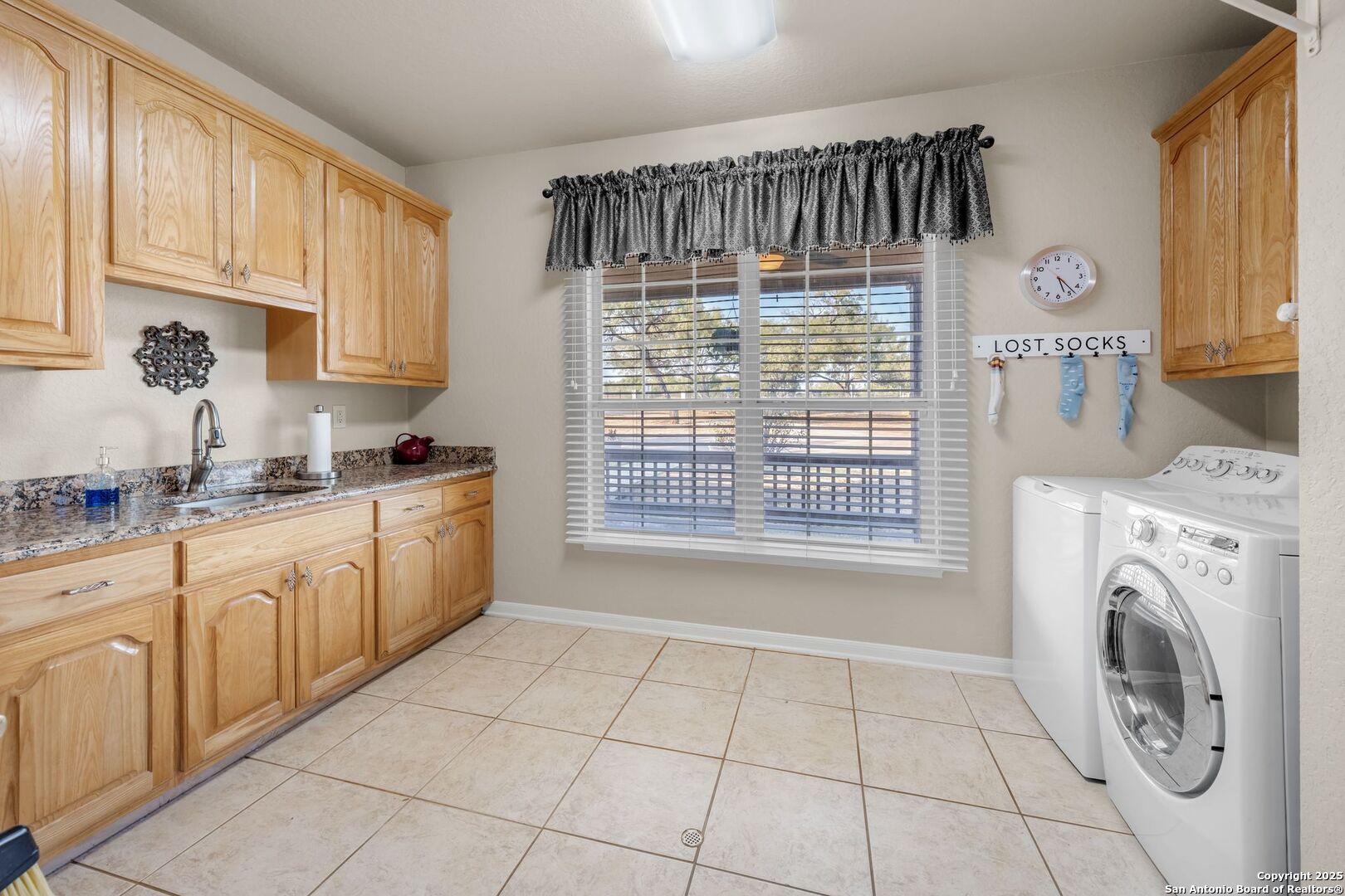 765 Highway 1604 Loop St. Hedwig, TX 78101 - Photo 19 of 50 a view of a kitchen with washing machine and windows