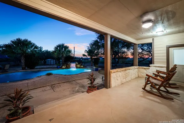 a view of a backyard with large trees