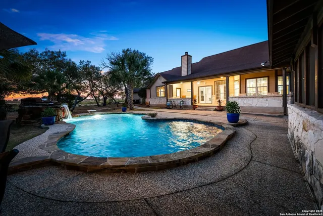 a view of a swimming pool with sitting area