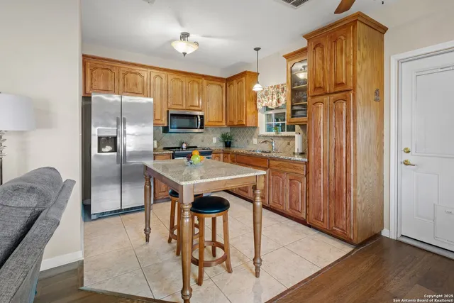 a bedroom with a bed a flat screen tv and a chandelier