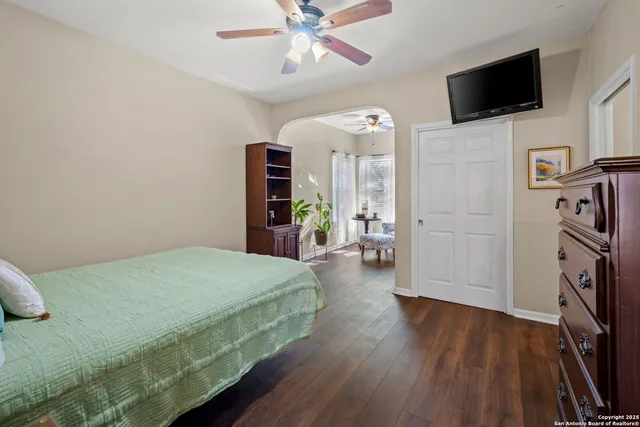 a bathroom with a granite countertop sink a toilet and a mirror