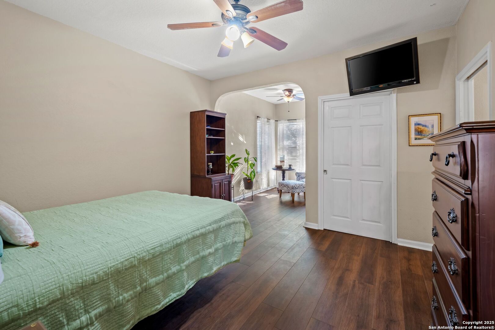 765 Highway 1604 Loop St. Hedwig, TX 78101 - Photo 43 of 50 a bedroom with a bed a flat screen tv and a chandelier