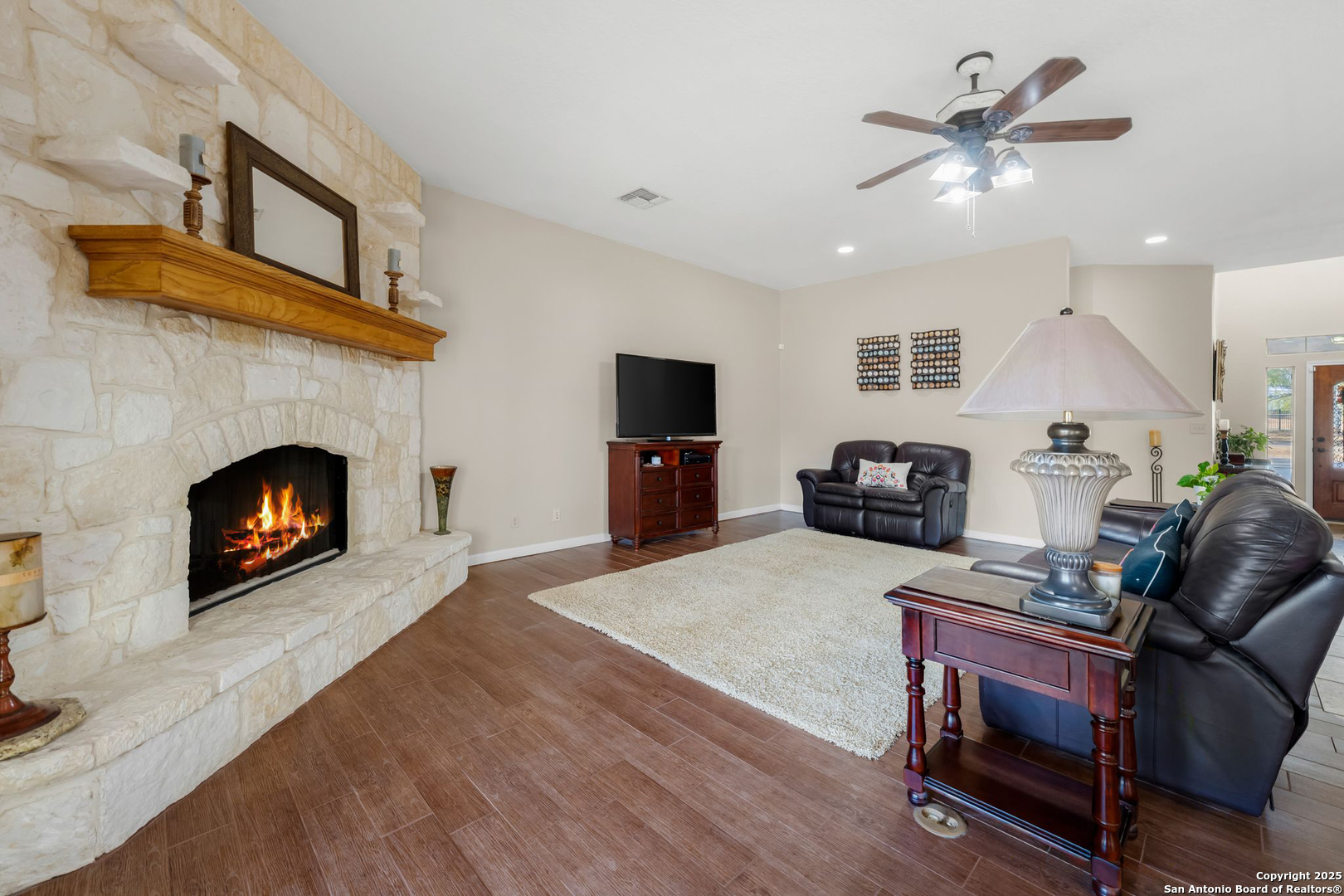 765 Highway 1604 Loop St. Hedwig, TX 78101 - Photo 10 of 50 a living room with furniture a fireplace and a flat screen tv