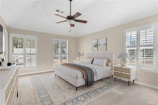 a spacious bedroom with a large bed and a window