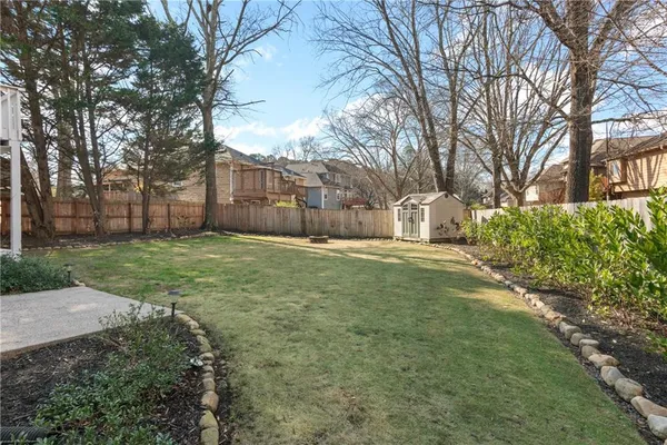a view of a yard with a large tree