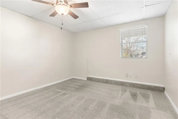 a view of a house with a big yard and large trees