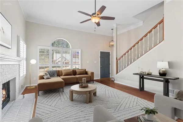 a living room with furniture a fireplace and a chandelier