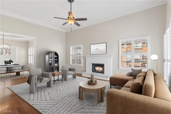 a living room with furniture a fireplace and a large window