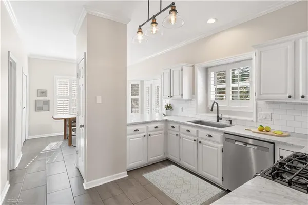 a kitchen that has a sink and a stove in it