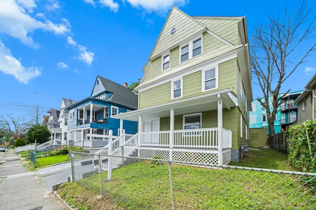 a front view of a house with a yard table and chairs