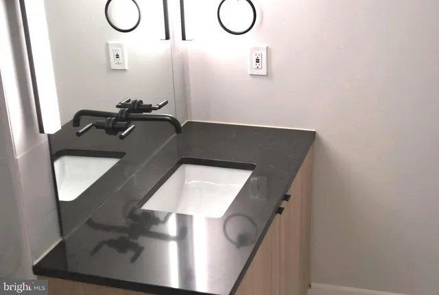 a sink sitting next to a bathroom sink