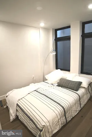 a bedroom with a bed and a large mirror