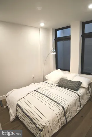 a bedroom with a bed and a large mirror
