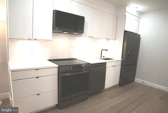 a view of a room with wooden floor