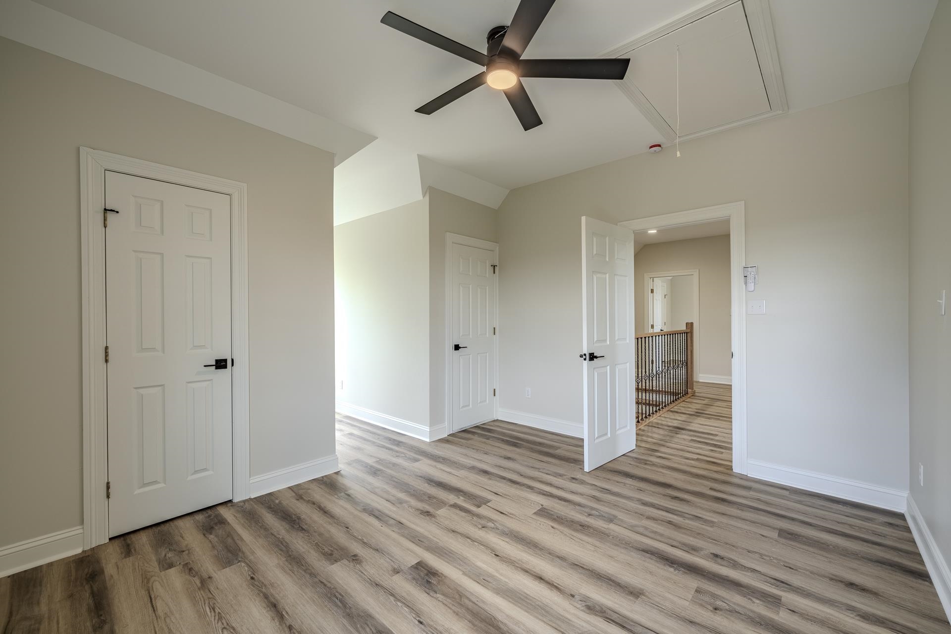 851 Rivers Edge Drive Bath Springs, TN 38311 - Photo 18 of 39 Spacious room featuring wood-finish flooring, light gray wall paint, and white trim