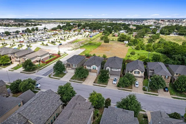 an aerial view of residential houses with outdoor space