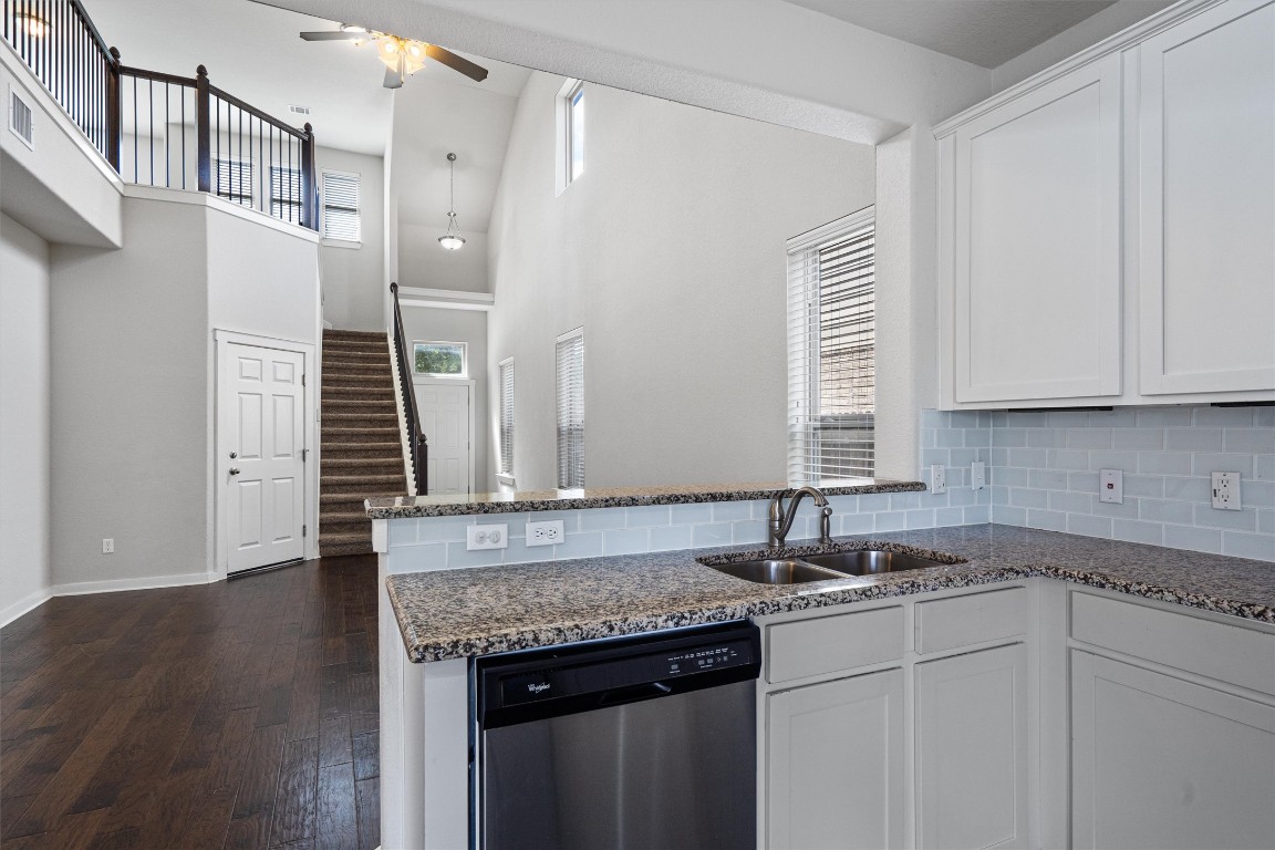 16304 Travesia Way Austin, TX 78728 - Photo 13 of 33 a kitchen with stainless steel appliances granite countertop a sink and a white cabinets