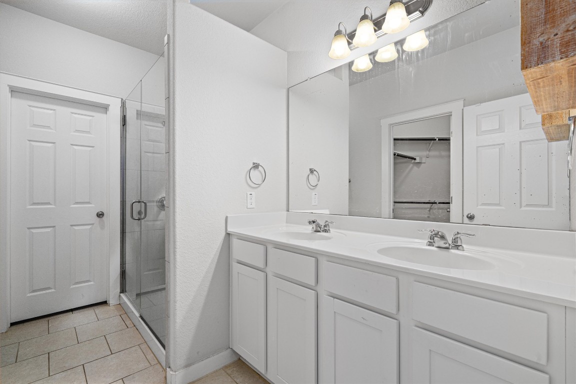 16304 Travesia Way Austin, TX 78728 - Photo 18 of 33 a bathroom with a double vanity sink mirror and vanity