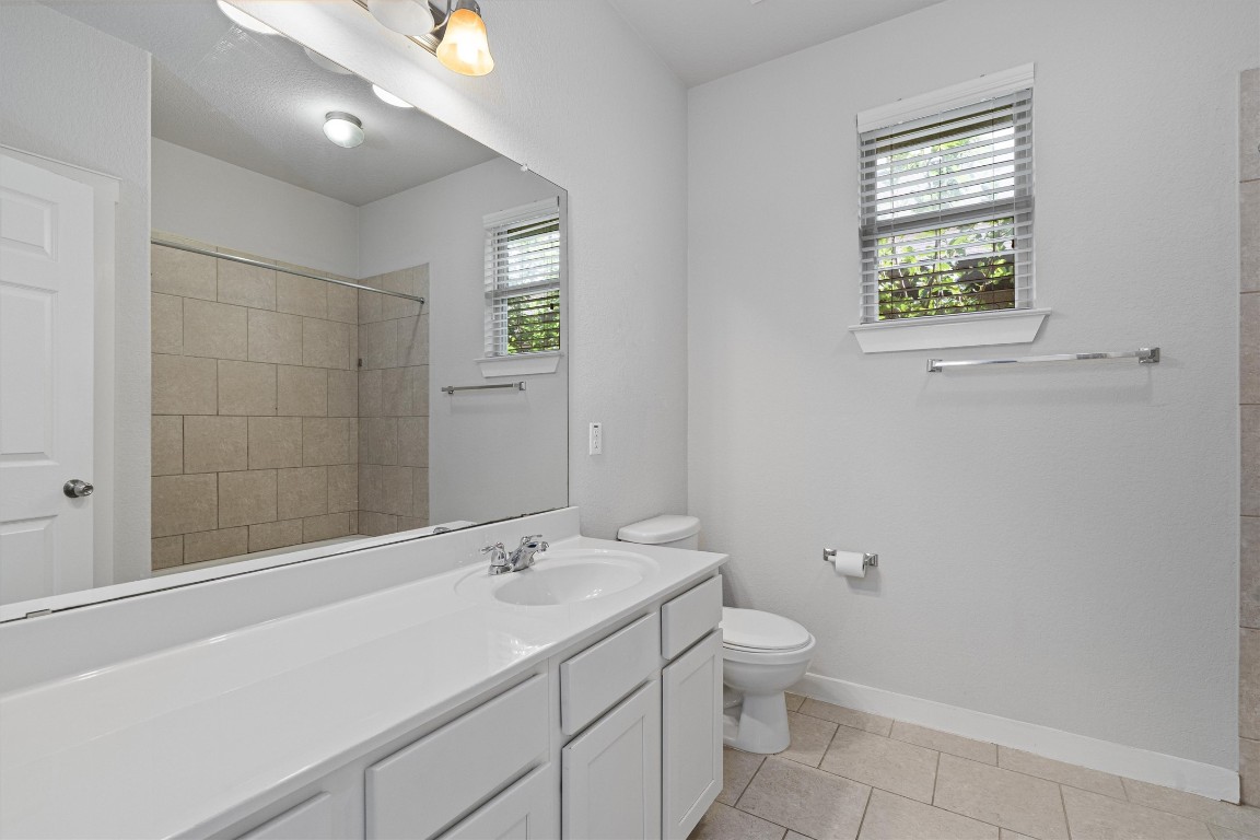 16304 Travesia Way Austin, TX 78728 - Photo 28 of 33 a bathroom with a sink a toilet and shower