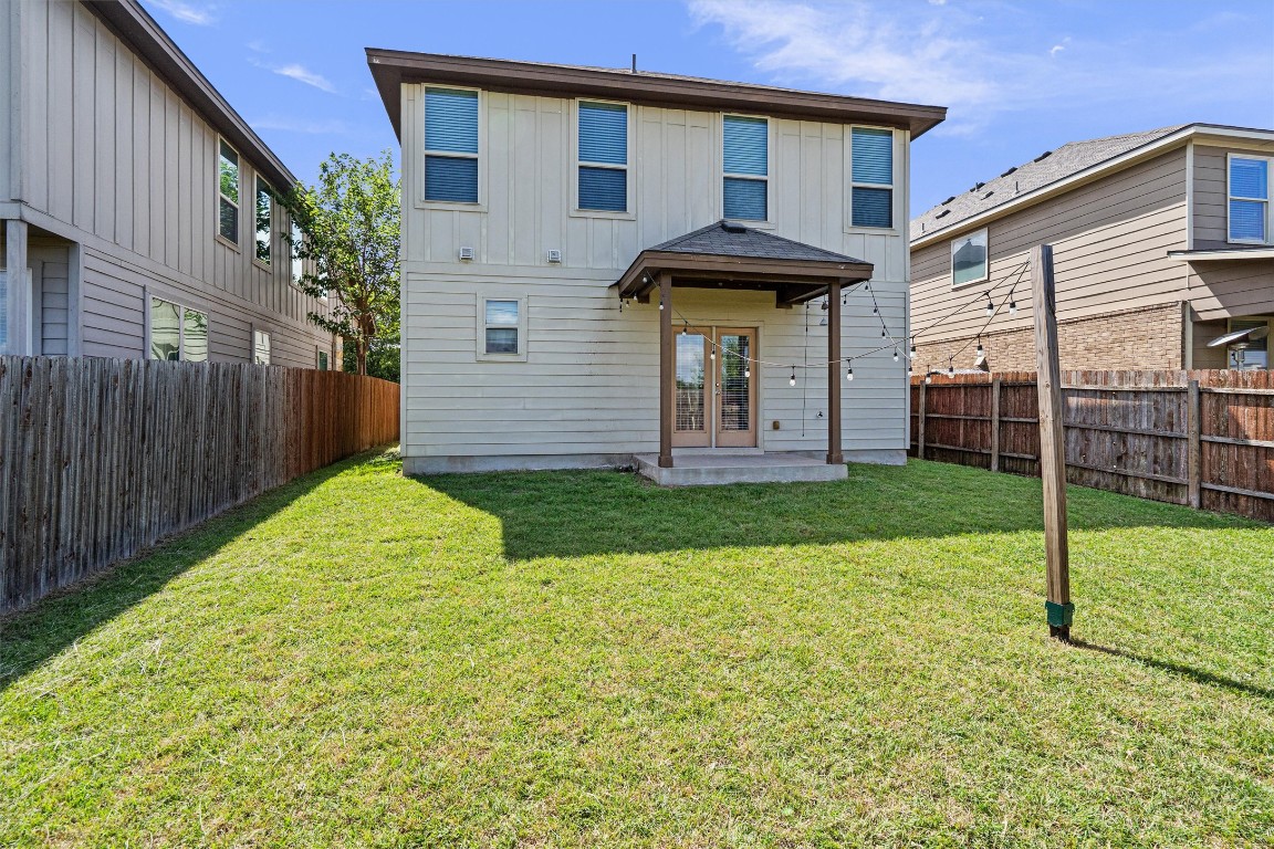 16304 Travesia Way Austin, TX 78728 - Photo 32 of 33 a view of a house with brick walls and a yard with plants
