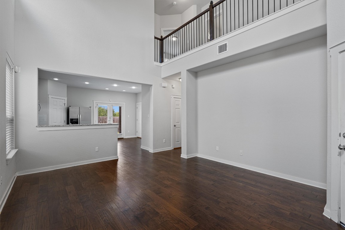 16304 Travesia Way Austin, TX 78728 - Photo 6 of 33 a view of an empty room with wooden floor