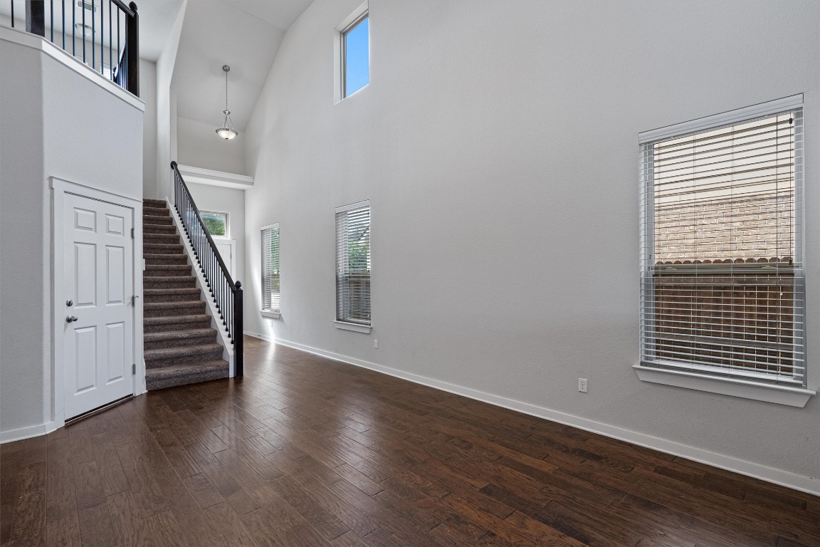 16304 Travesia Way Austin, TX 78728 - Photo 7 of 33 wooden floor in an empty room with a window