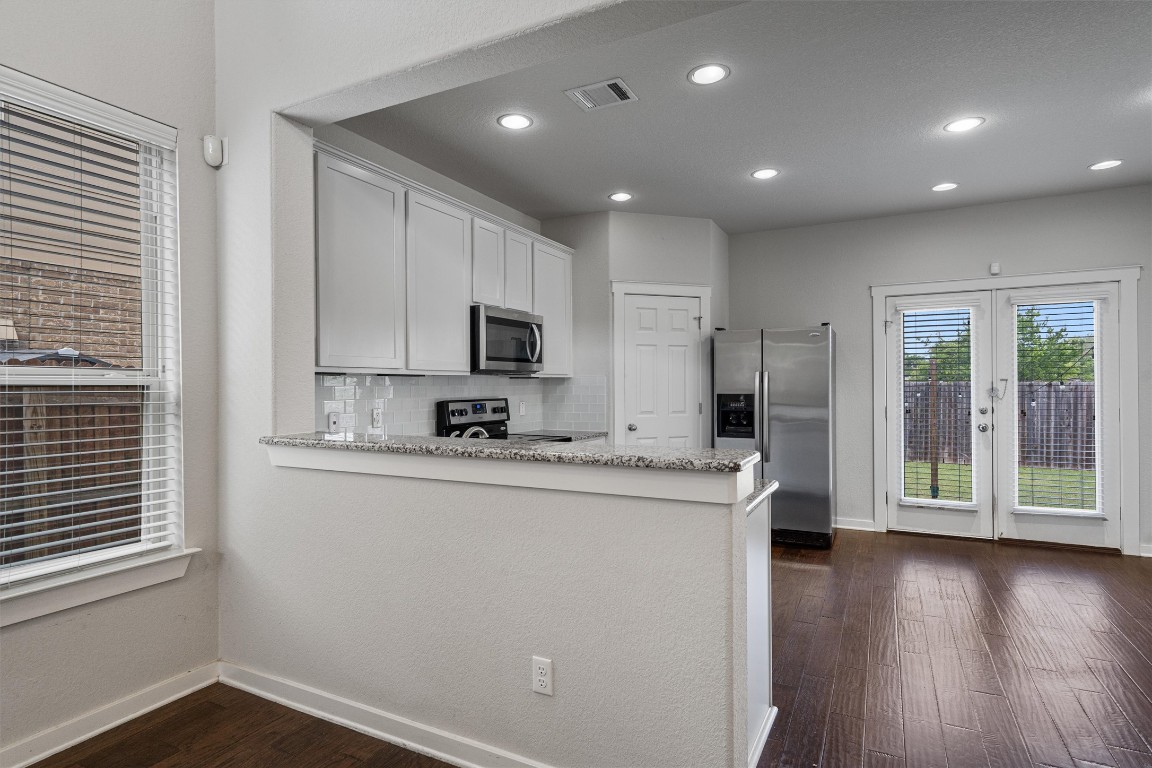 16304 Travesia Way Austin, TX 78728 - Photo 8 of 33 a kitchen with stainless steel appliances a refrigerator sink and microwave