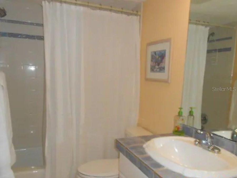 13650 Gulf Boulevard, Unit 304 Madeira Beach, FL 33708 - Photo 57 of 63 a bathroom with a sink toilet and vanity