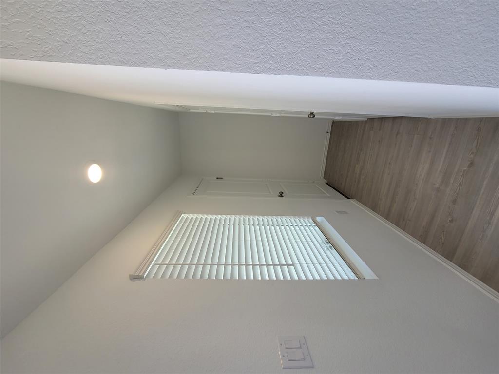 105 Painted Night Road Hutto, TX 78634 - Photo 2 of 8 a view of an empty room with wooden floor and a window